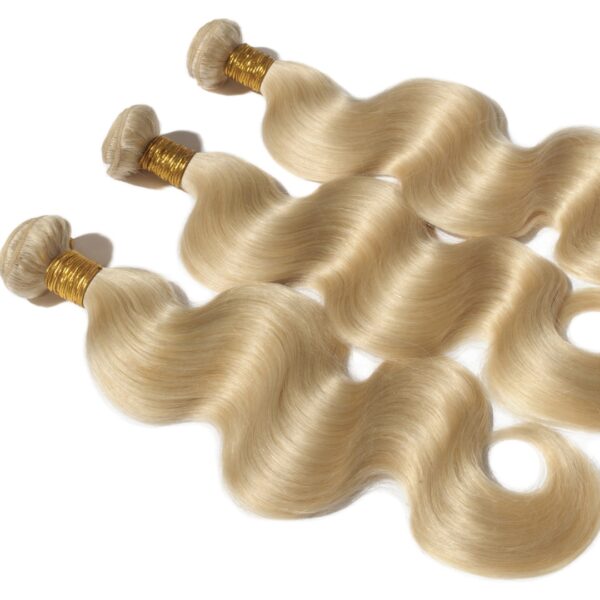 Three blonde hair extensions laying on top of each other.