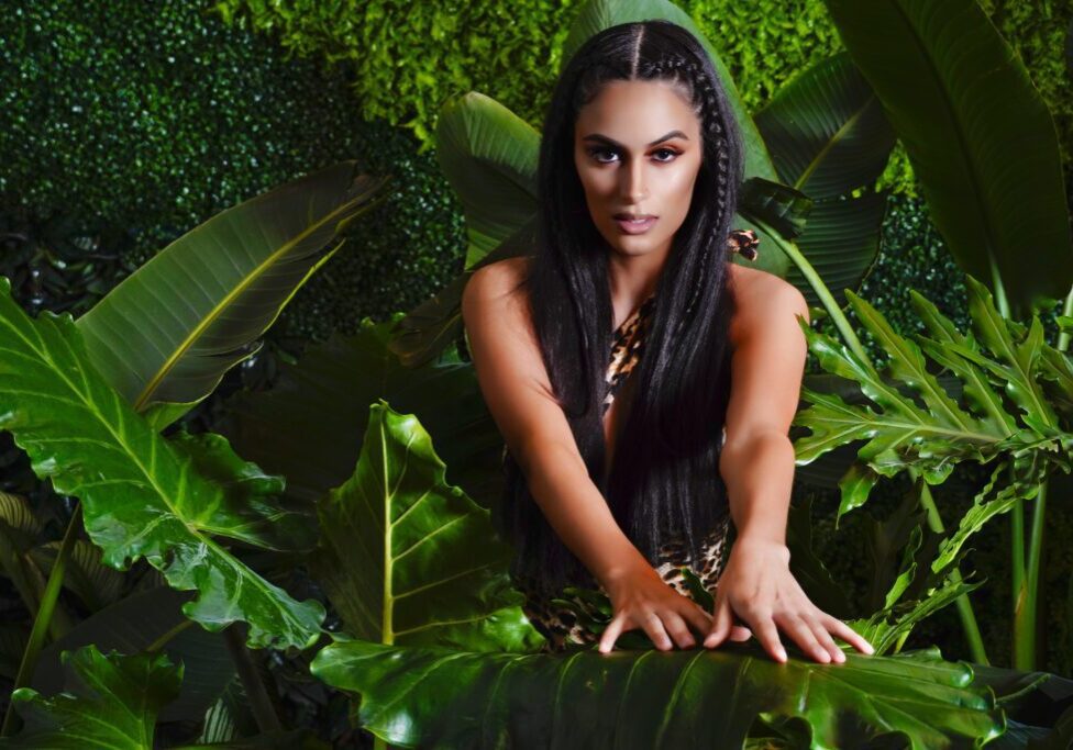 A woman sitting in the middle of some plants