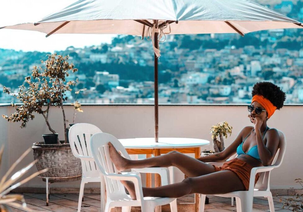 A woman in a bikini sitting on top of a chair.